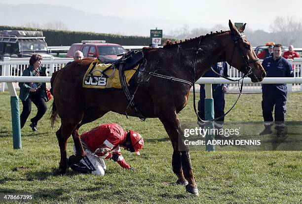 Jockey Ruby Walsh lies injured after falling from Abbyssial during the The JCB Triumph Hurdle race on the final day of the Cheltenham Festival horse...