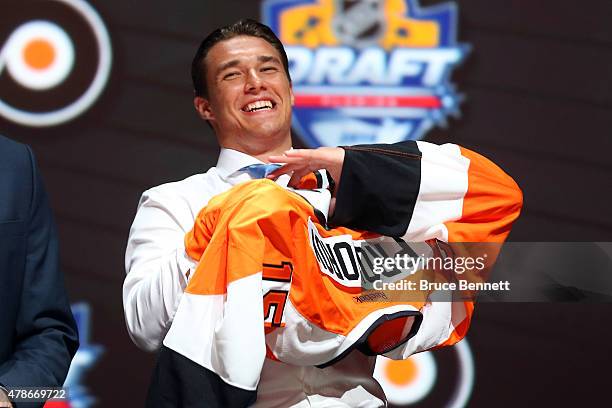 Ivan Provorov puts on his jersey after being selected seventh overall by the Philadelphia Flyers in the first round of the 2015 NHL Draft at BB&T...