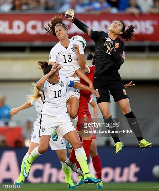Goalkeeper Fei Wang of China is challenged by Carli Lloyd of USA and Alex Morgan of USA during the FIFA Women's World Cup 2015 Quarter Final match...