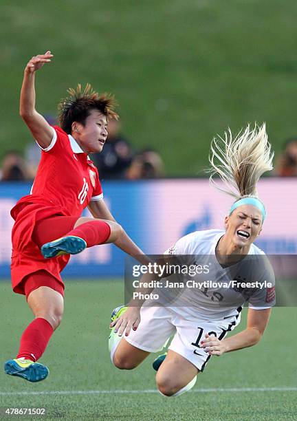 Lou Jiahui of China and Julie Johnston of the United States collide in the first half in the FIFA Women's World Cup 2015 Quarter Final match at...