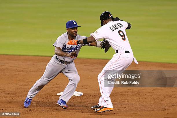 Jose Oquendo of the Los Angeles Dodgers tags out Dee Gordon of the Miami Marlins during the third inning of the game at Marlins Park on June 26, 2015...
