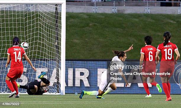 Carli Lloyd of the United States celebrates as she heads the ball past goalkeeper Wang Fei of China in the second half for her team's first goal in...