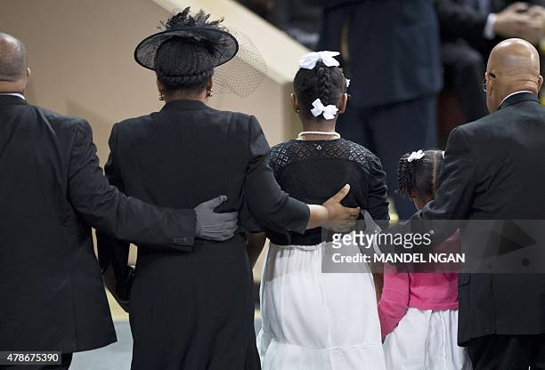 Jennifer Pinckney , the wife of Rev. And South Carolina State Sen. Clementa Pickney with daughters Eliana and Malana stand at a funeral before US...