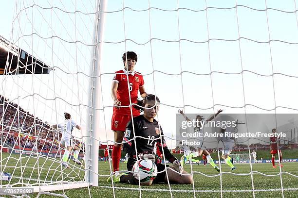 Li Dongna and goalkeeper Wang Fei of China react as the United States celebrate their first goal in the second half by Carli Lloyd in the FIFA...