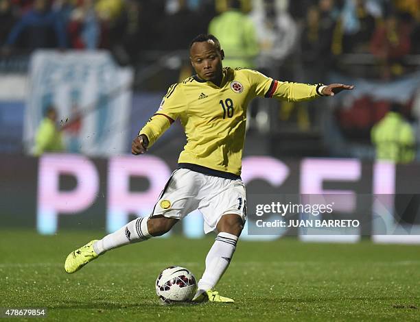 Colombia's defender Camilo Zuniga strikes the ball during the penalty shoot-out against Argentina only to Argentina's goalkeeper Sergio Romero...