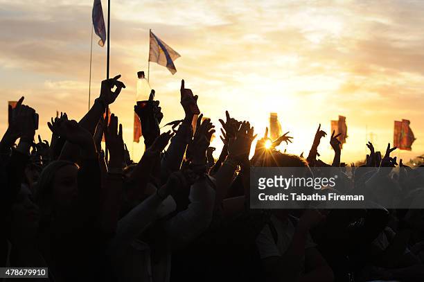 The sun sets on the festival crowd at the Glastonbury Festival at Worthy Farm, Pilton on June 26, 2015 in Glastonbury, England.