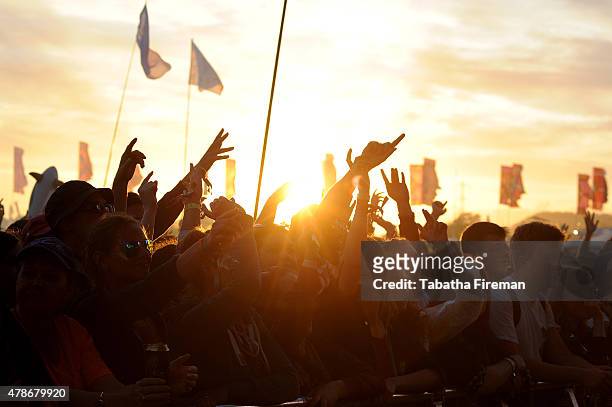 The sun sets on the festival crowd at the Glastonbury Festival at Worthy Farm, Pilton on June 26, 2015 in Glastonbury, England.