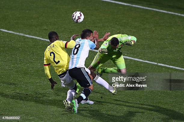 Carlos Tevez of Argentina clashes with David Ospina of Colombia and Cristian Zapata of Colombia during the 2015 Copa America Chile quarter final...