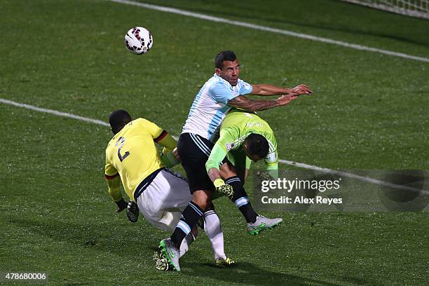 Carlos Tevez of Argentina clashes with David Ospina of Colombia and Cristian Zapata of Colombia during the 2015 Copa America Chile quarter final...