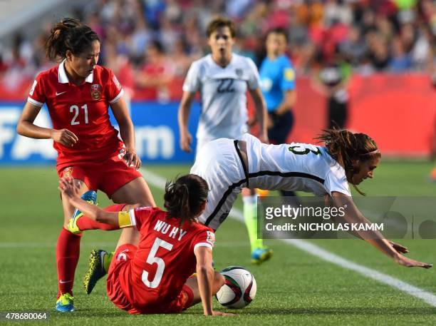 Player Alex Morgan falls over China's Wu Haiyan during their 2015 FIFA Women's World Cup quarterfinal match against China at Lansdowne Stadium in...