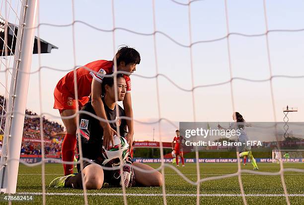 Fei Wang of China looks dejected after Carli Lloyd of USA scored the first goal during the FIFA Women's World Cup 2015 Quarter Final match between...