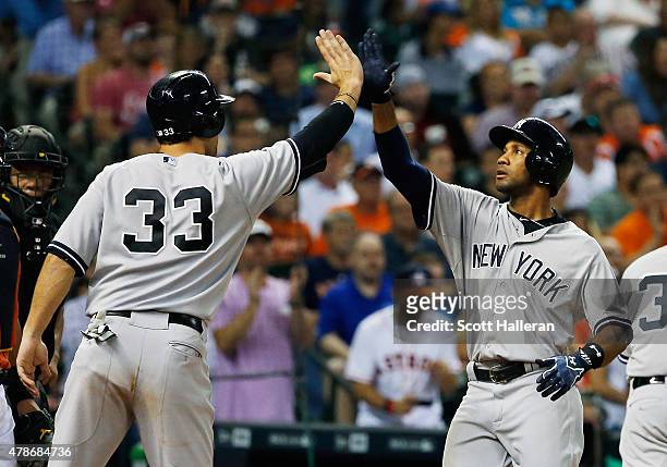 Chris Young and Garrett Jones of the New York Yankees celebrate after Young hit a three-run home run in the seventh inning during their game against...