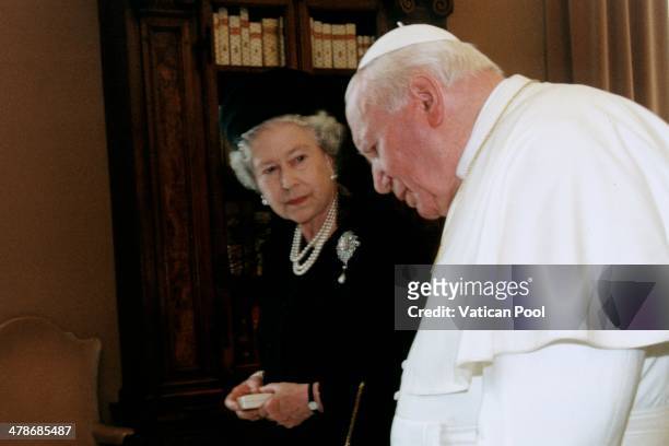 Queen Elizabeth II and Prince Philip leave after a meeting with Pope John Paul II at his private library in the Apostolic Palace on October 17, 2000...