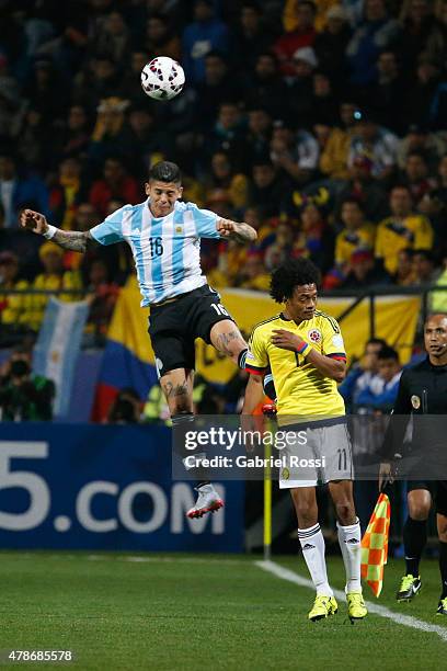 Marcos Rojo of Argentina goes for a header with Juan Guillermo Cuadrado of Colombia during the 2015 Copa America Chile quarter final match between...