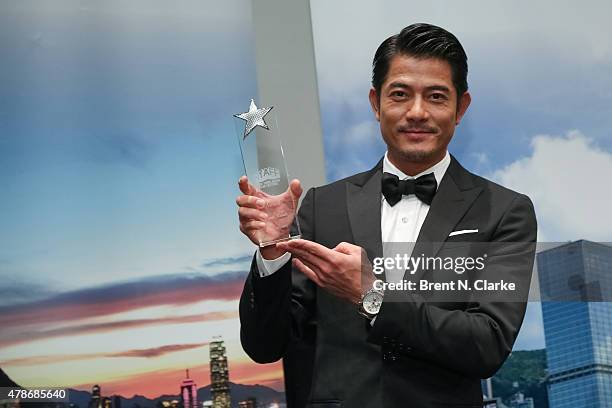 Actor/singer and Star Asia Award recipient Aaron Kwok poses for photographs during the 2015 New York Asian Film Festival opening night reception held...