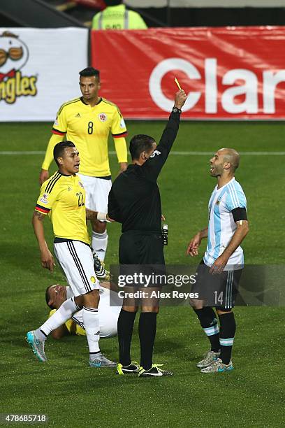 Referee Roberto Garcia shows a yellow card to Javier Mascherano of Argentina during the 2015 Copa America Chile quarter final match between Argentina...