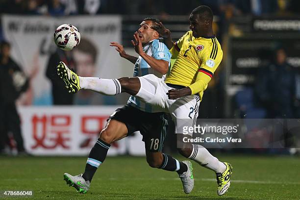 Carlos Tevez of Argentina fights for the ball with Cristian Zapata of Colombia during the 2015 Copa America Chile quarter final match between...