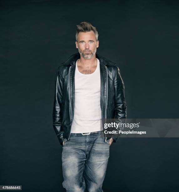 he has his own sense of style - leather trousers stockfoto's en -beelden