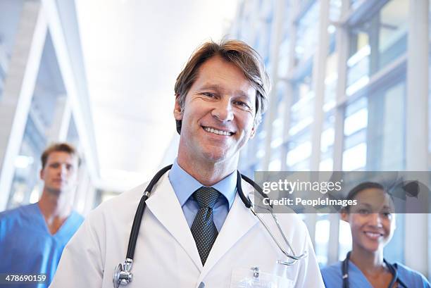 leading his medical team with perfection - peopleimages hospital stock pictures, royalty-free photos & images