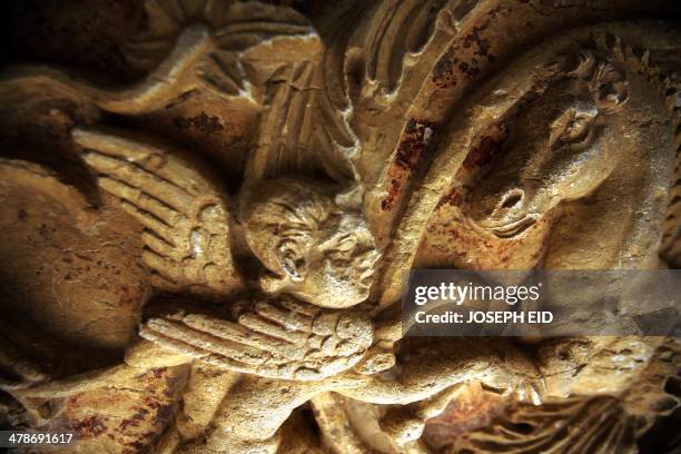 Picture taken on March 14, 2014 shows carvings on a wall in the courtyard of the sanctury of Baal in the ancient oasis city of Palmyra, 215...