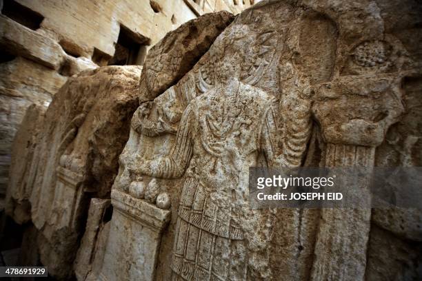 Picture taken on March 14, 2014 shows carvings on a wall in the courtyard of the sanctury of Baal in the ancient oasis city of Palmyra, 215...