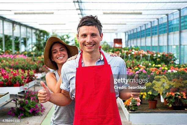 couple in a garden center store - sean gardner stock pictures, royalty-free photos & images