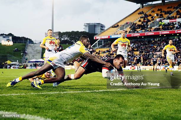 Bodene Thompson of the Warriors scores a try against Edrick Lee of the Raiders during the round 16 NRL match between the New Zealand Warriors and the...