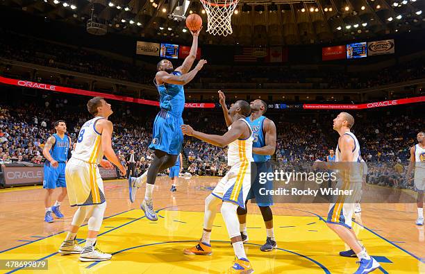 Bernard James of the Dallas Mavericks shoots a layup against the Golden State Warriors on March 11, 2014 at Oracle Arena in Oakland, California. NOTE...