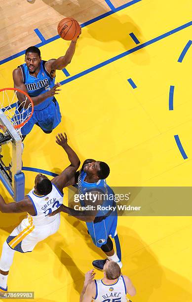 Bernard James of the Dallas Mavericks shoots against the Golden State Warriors on March 11, 2014 at Oracle Arena in Oakland, California. NOTE TO...