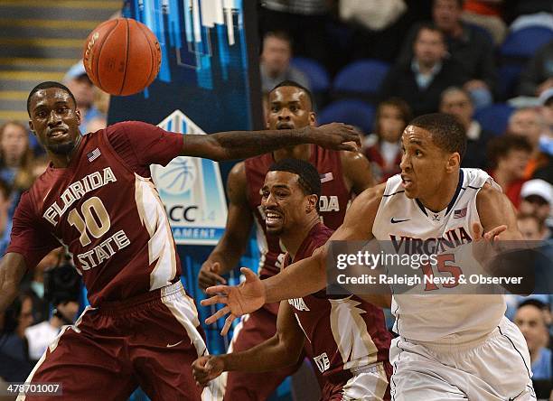 Virginia guard Malcolm Brogdon chases after a loose ball in the second half of play as Florida State forward Okaro White , guard Devon Bookert and...