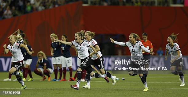 The German players celebrate after their victory over France 5-4 on penalties during the FIFA Women's World Cup 2015 quarter final match between...
