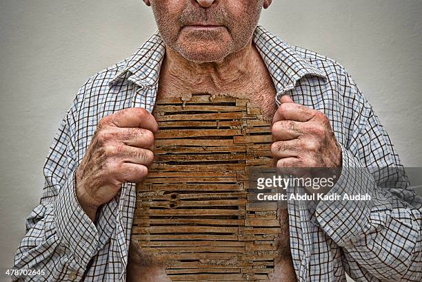 old man exposing chest of woven wattle - un solo hombre mayor camisa fotografías e imágenes de stock