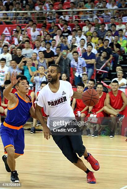 Star Tony Parker plays basketball with fans during his visit in China on June 26, 2015 in Shaoxing, Zhejiang province of China.