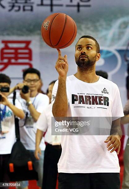 Star Tony Parker plays basketball with fans during his visit in China on June 26, 2015 in Shaoxing, Zhejiang province of China.