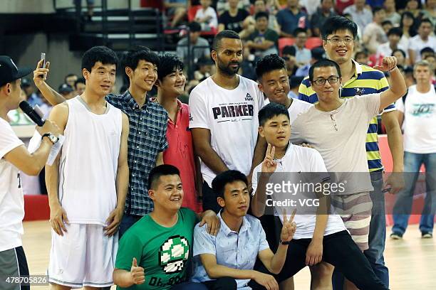 Star Tony Parker poses with fans during his visit in China on June 26, 2015 in Shaoxing, Zhejiang province of China.