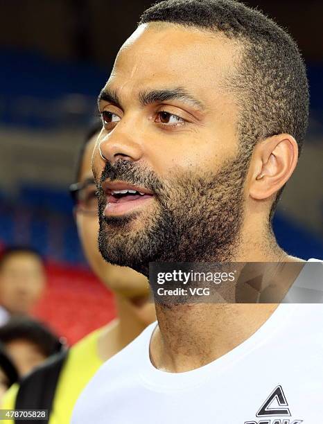 Star Tony Parker plays basketball with fans during his visit in China on June 26, 2015 in Shaoxing, Zhejiang province of China.