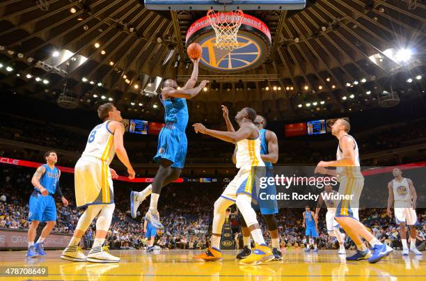 Bernard James of the Dallas Mavericks shoots against the Golden State Warriors on March 11, 2014 at Oracle Arena in Oakland, California. NOTE TO...