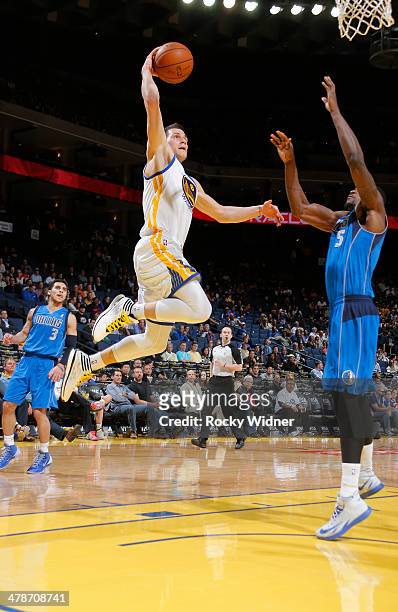 Nemanja Nedovic of the Golden State Warriors goes up for the dunk against Bernard James of the Dallas Mavericks on March 11, 2014 at Oracle Arena in...