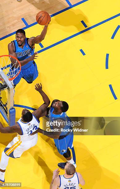 Bernard James of the Dallas Mavericks shoots against the Golden State Warriors on March 11, 2014 at Oracle Arena in Oakland, California. NOTE TO...