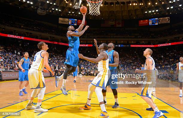 Bernard James of the Dallas Mavericks shoots a layup against the Golden State Warriors on March 11, 2014 at Oracle Arena in Oakland, California. NOTE...