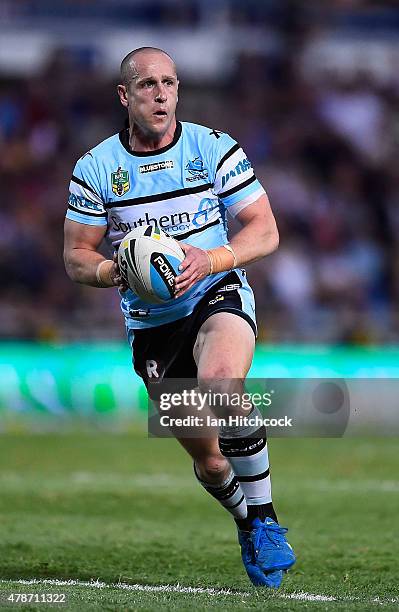 Jeff Robson of the Sharks runs the ball during the round 16 NRL match between the North Queensland Cowboys and the Cronulla Sharks at 1300SMILES...