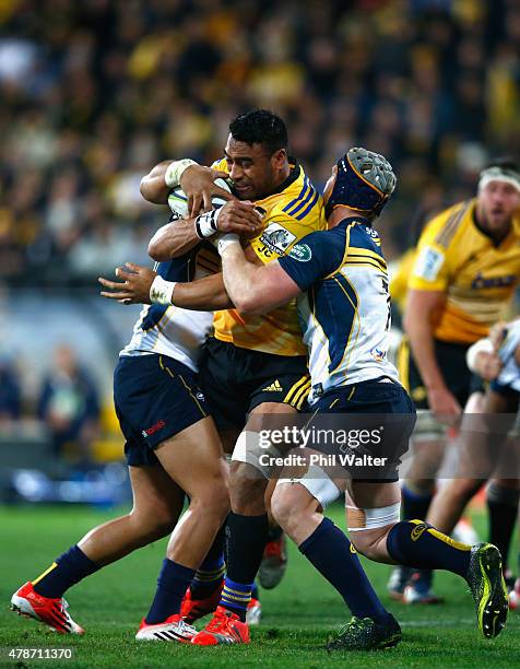 Victor Vito of the Hurricanes is tackled during the Super Rugby Semi Final match between the Hurricanes and the Brumbies at Westpac Stadium on June...