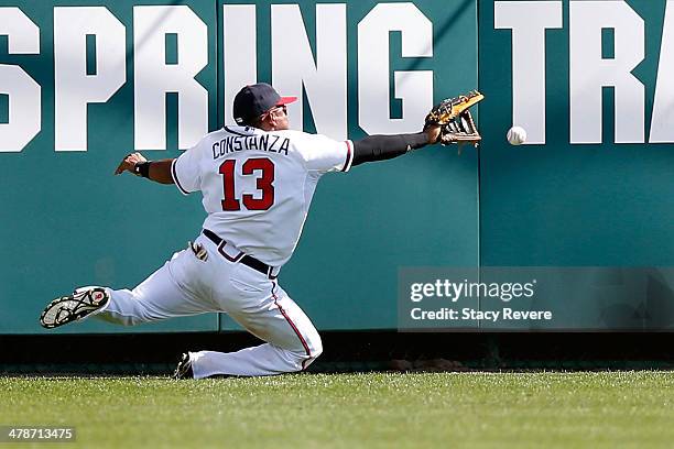 Jose Constanza of the Atlanta Braves is unable to field a fly ball in the ninth inning of a game against the Tampa Bay Rays at Champion Stadium on...