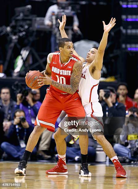 LaQuinton Ross of the Ohio State Buckeyes looks to pass the ball while defended by Tai Webster the Nebraska Cornhuskers during the Quarterfinals of...