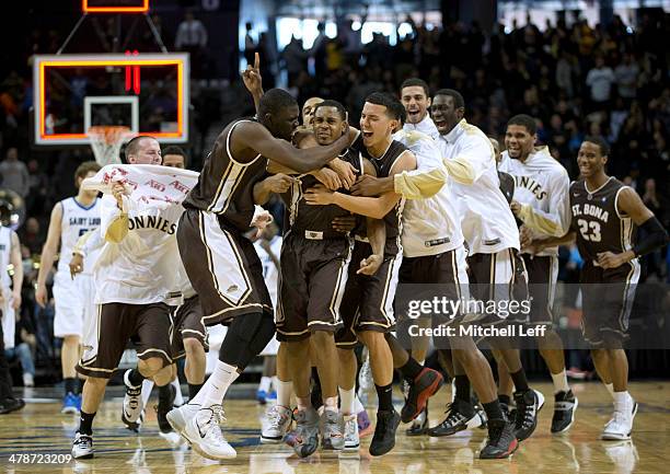 St. Bonaventure Bonnies team pile on guard Jordan Gathers who hit the game winning shot against the St. Louis Billikens in the Quarterfinals of the...