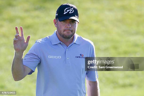 Robert Garrigus acknowledges the gallery on the 15th hole during the second round of the Valspar Championship at Innisbrook Resort and Golf Club on...