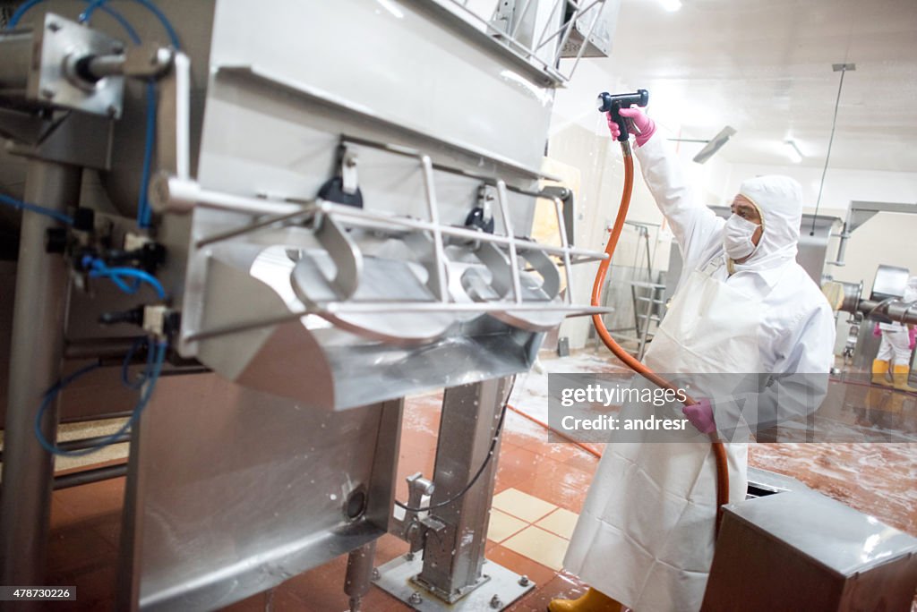 Man washing machines at a factory