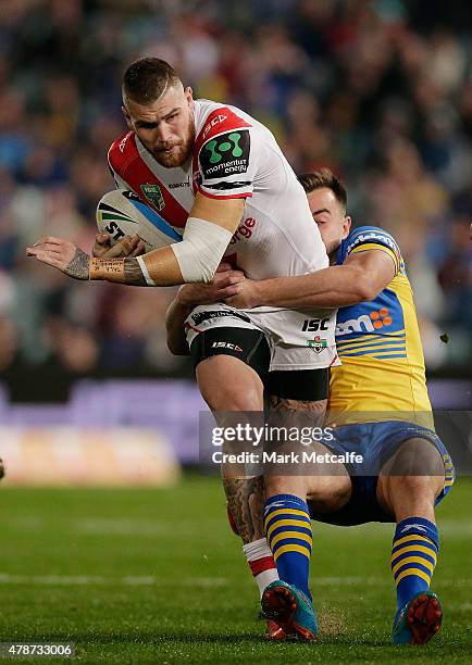 Josh Dugan of the Dragons is tackled during the round 16 NRL match between the Parramatta Eels and the St George Illawarra Dragons at Pirtek Stadium...