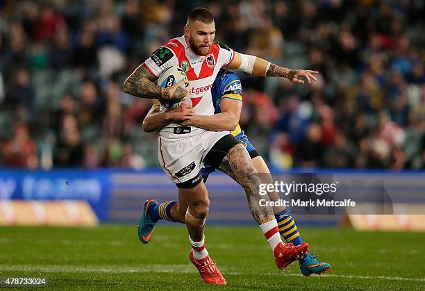 Josh Dugan of the Dragons is tackled during the round 16 NRL match between the Parramatta Eels and the St George Illawarra Dragons at Pirtek Stadium...