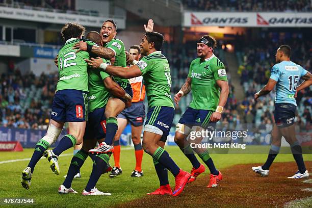 Patrick Osborne of the Highlanders celebrates with Richard Buckman and Aaron Smith after scoring the final try during the Super Rugby Semi Final...